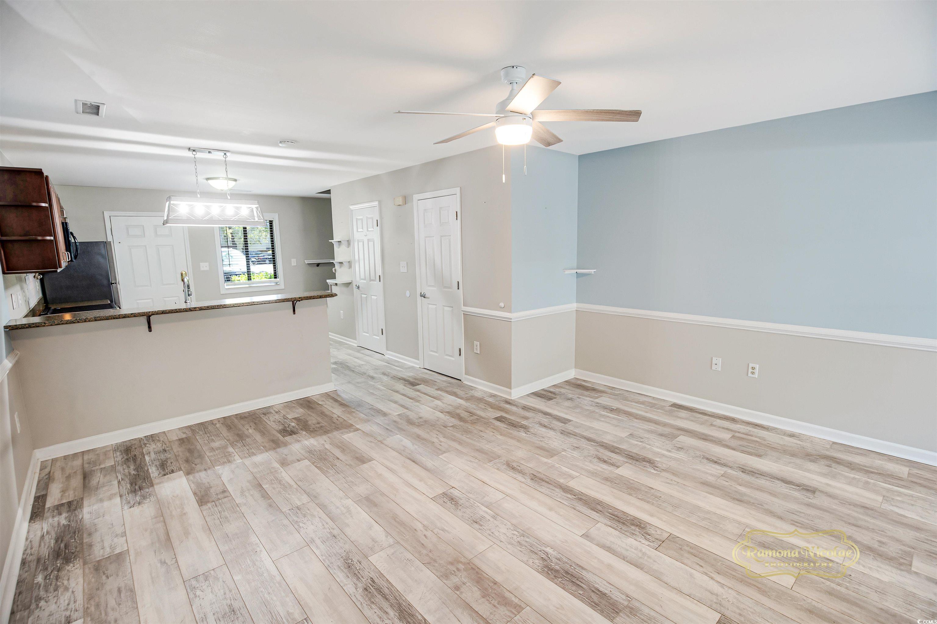 5161 Inlet Garden Court, Unit 8C Murrells Inlet, SC 29576 - Photo 10 of 31 Unfurnished living room with visible vents, light