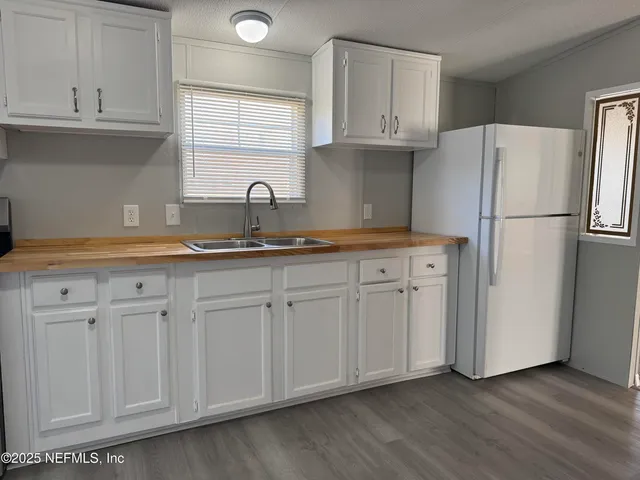a kitchen with appliances cabinets and a sink