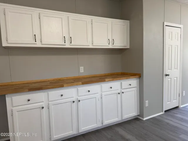 a view of cabinets with wooden floor