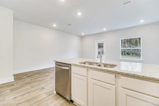 a hallway with a sink and a window