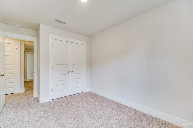 an empty room with closet area