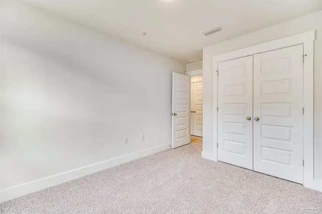 an empty room with closet area