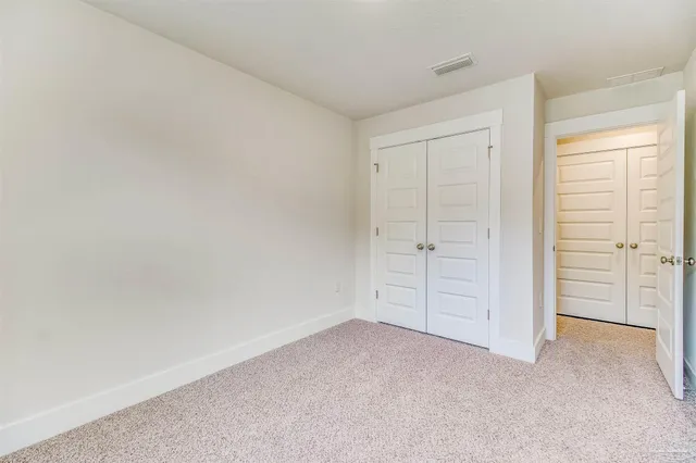 an empty room with closet area