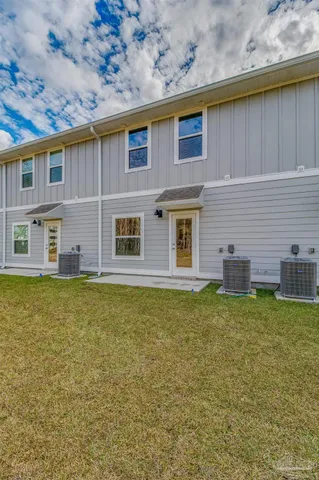 a backyard of a house with table and chairs