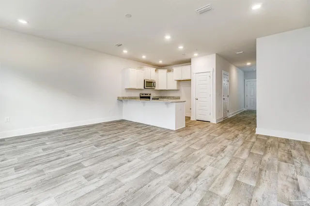 a view of kitchen with refrigerator sink and cabinets