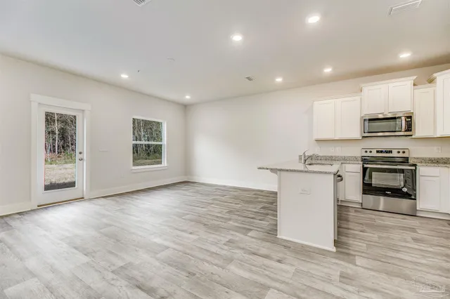 a view of kitchen with microwave and stove