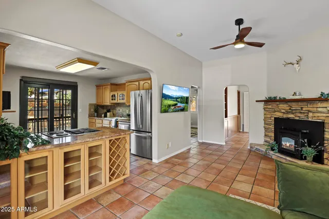 a open kitchen with granite countertop a stove a refrigerator and cabinets