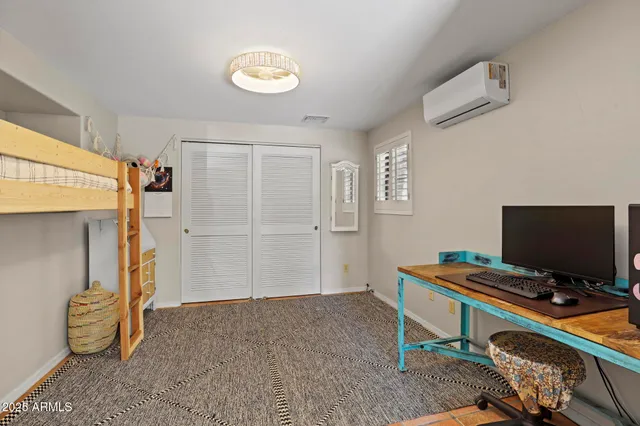 a view of a workspace with furniture and a flat screen tv