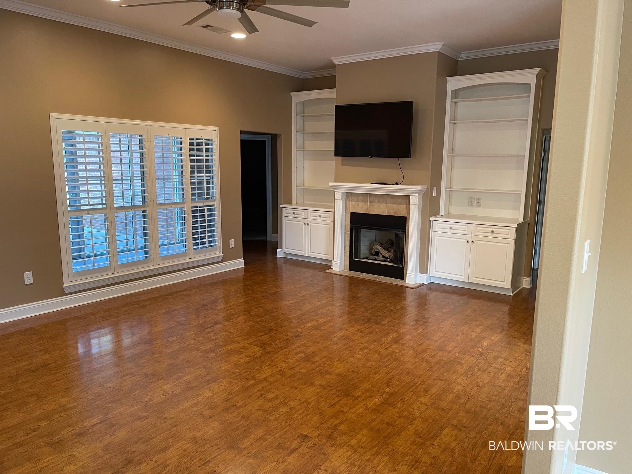 109 Savannah Circle Foley, AL 36535 - Photo 4 of 17 Unfurnished living room with ceiling fan, crown molding, a fireplace, and dark wood-type flooring