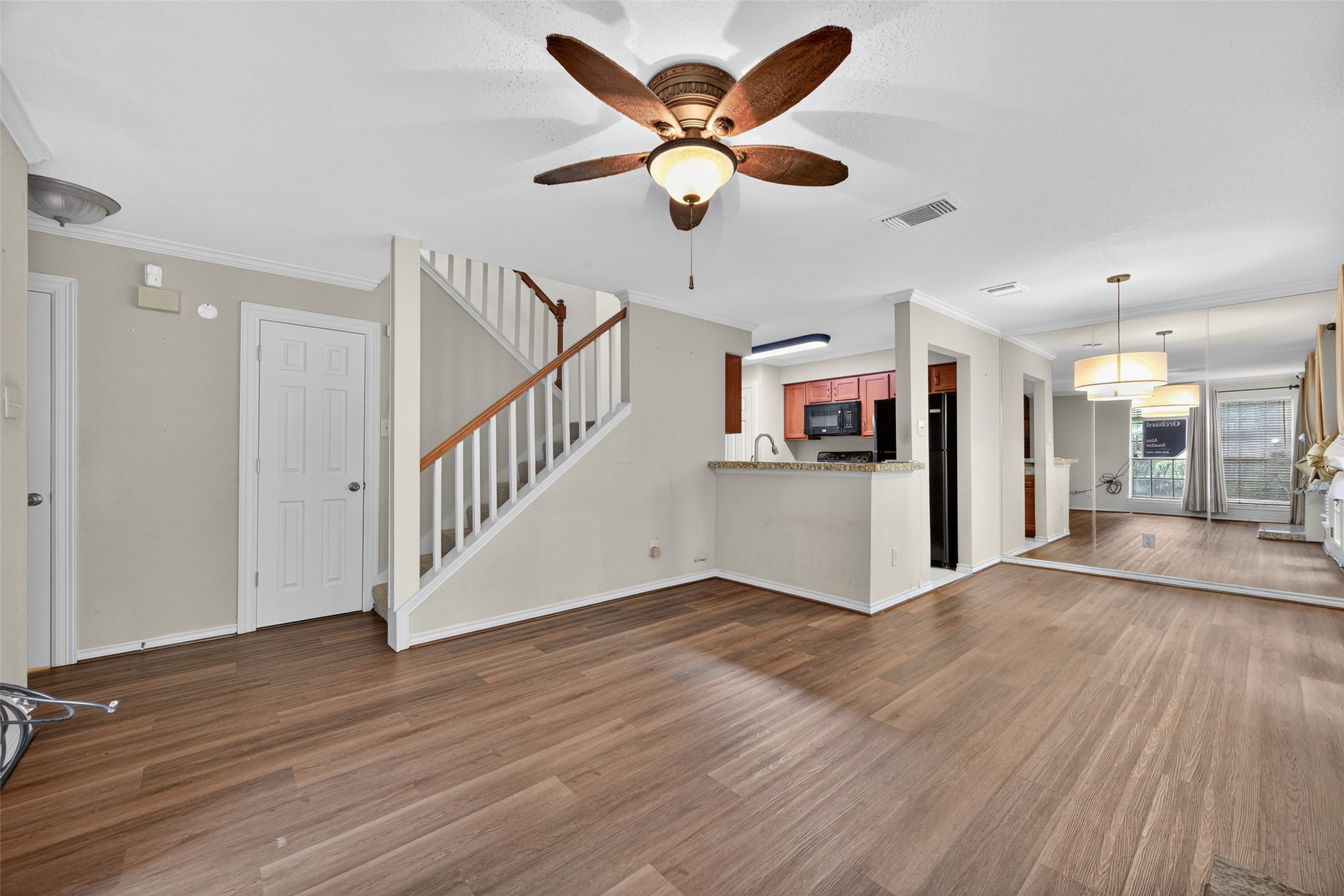 2211 South Kirkwood Road, Unit 49 Houston, TX 77077 - Photo 11 of 34 a view of a livingroom with a hardwood floor and a ceiling fan