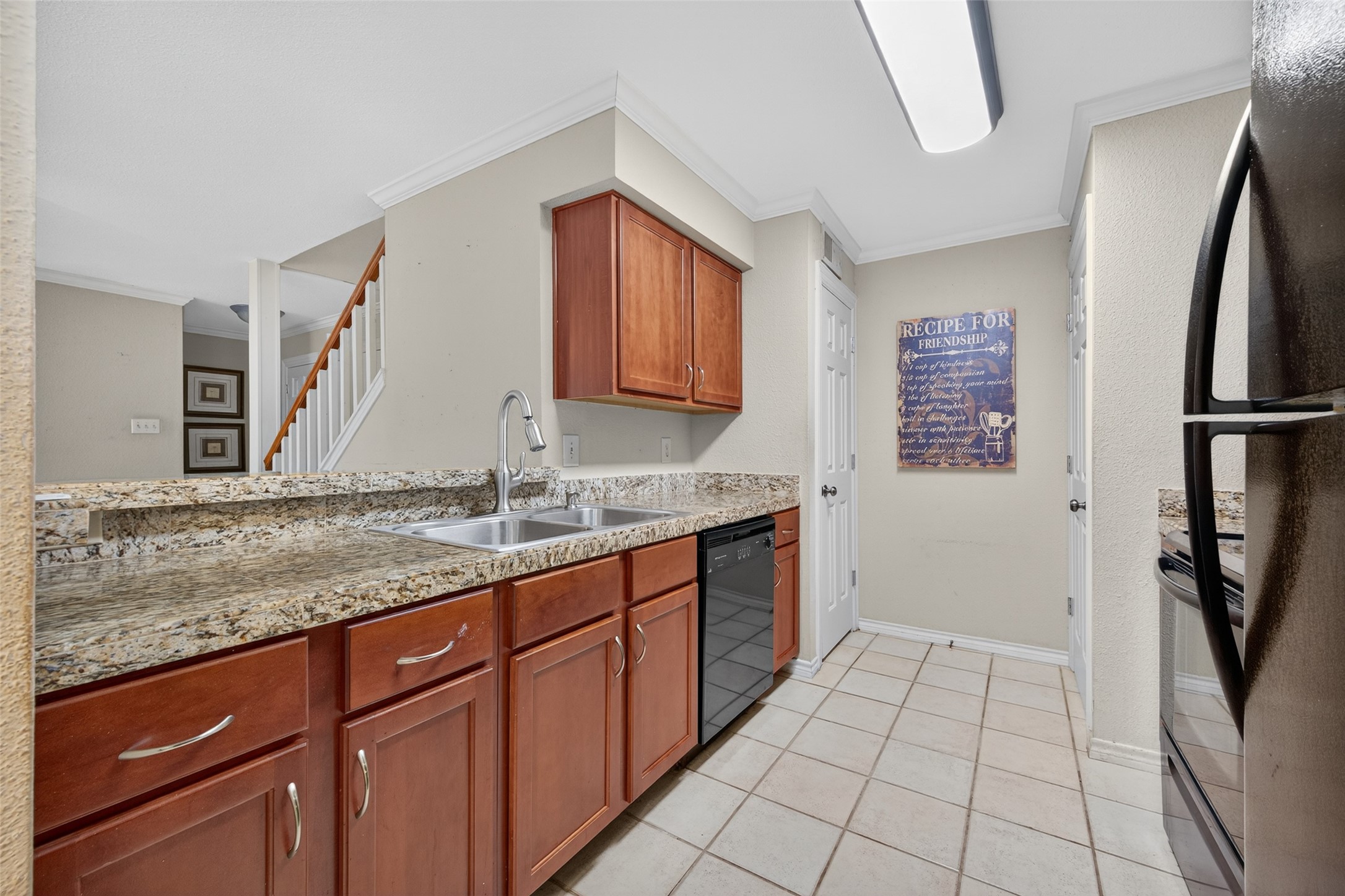 2211 South Kirkwood Road, Unit 49 Houston, TX 77077 - Photo 16 of 34 a kitchen with a sink stove and refrigerator