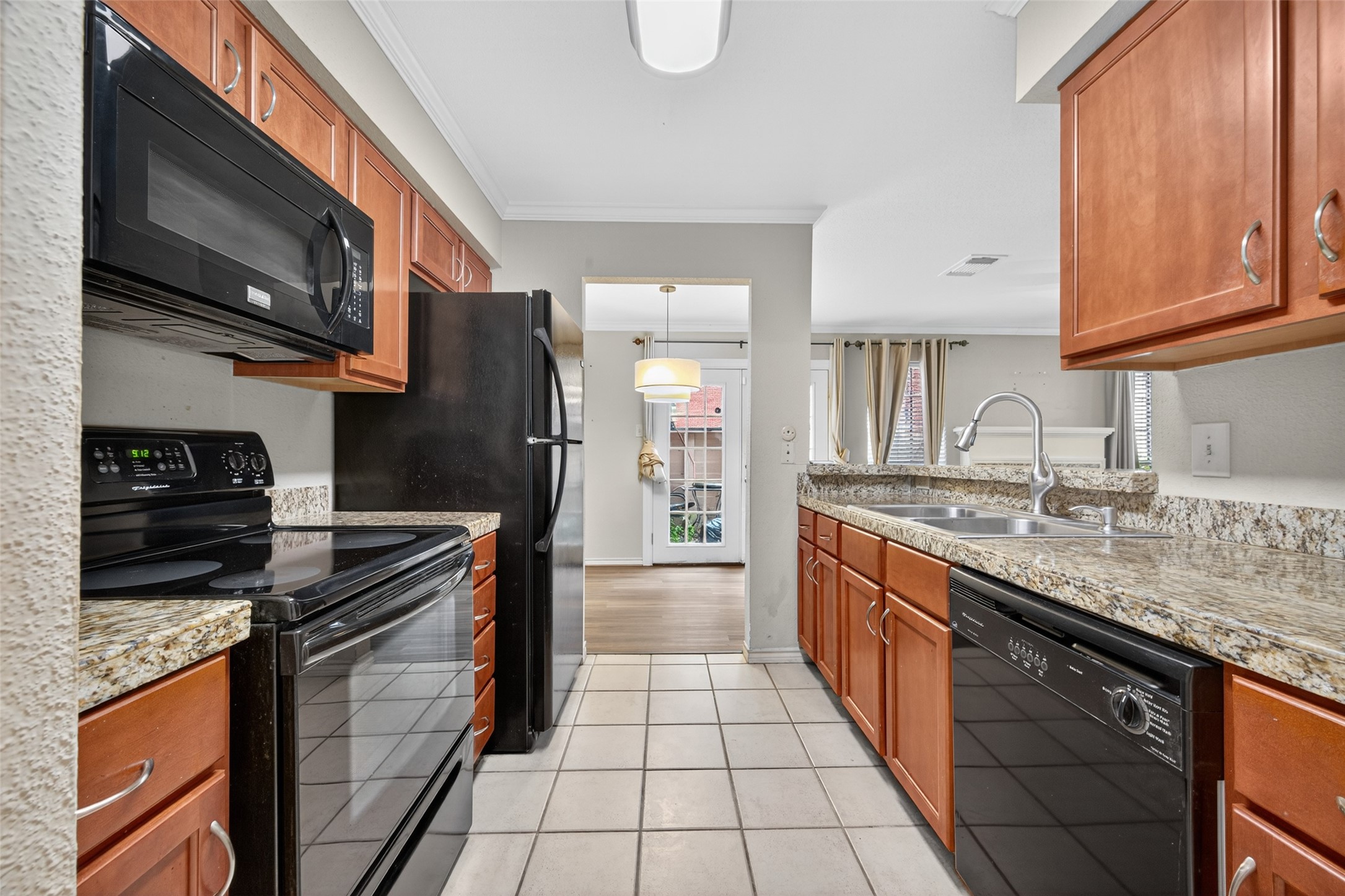 2211 South Kirkwood Road, Unit 49 Houston, TX 77077 - Photo 17 of 34 a kitchen with stainless steel appliances granite countertop a stove top oven a sink dishwasher and a refrigerator with wooden cabinets