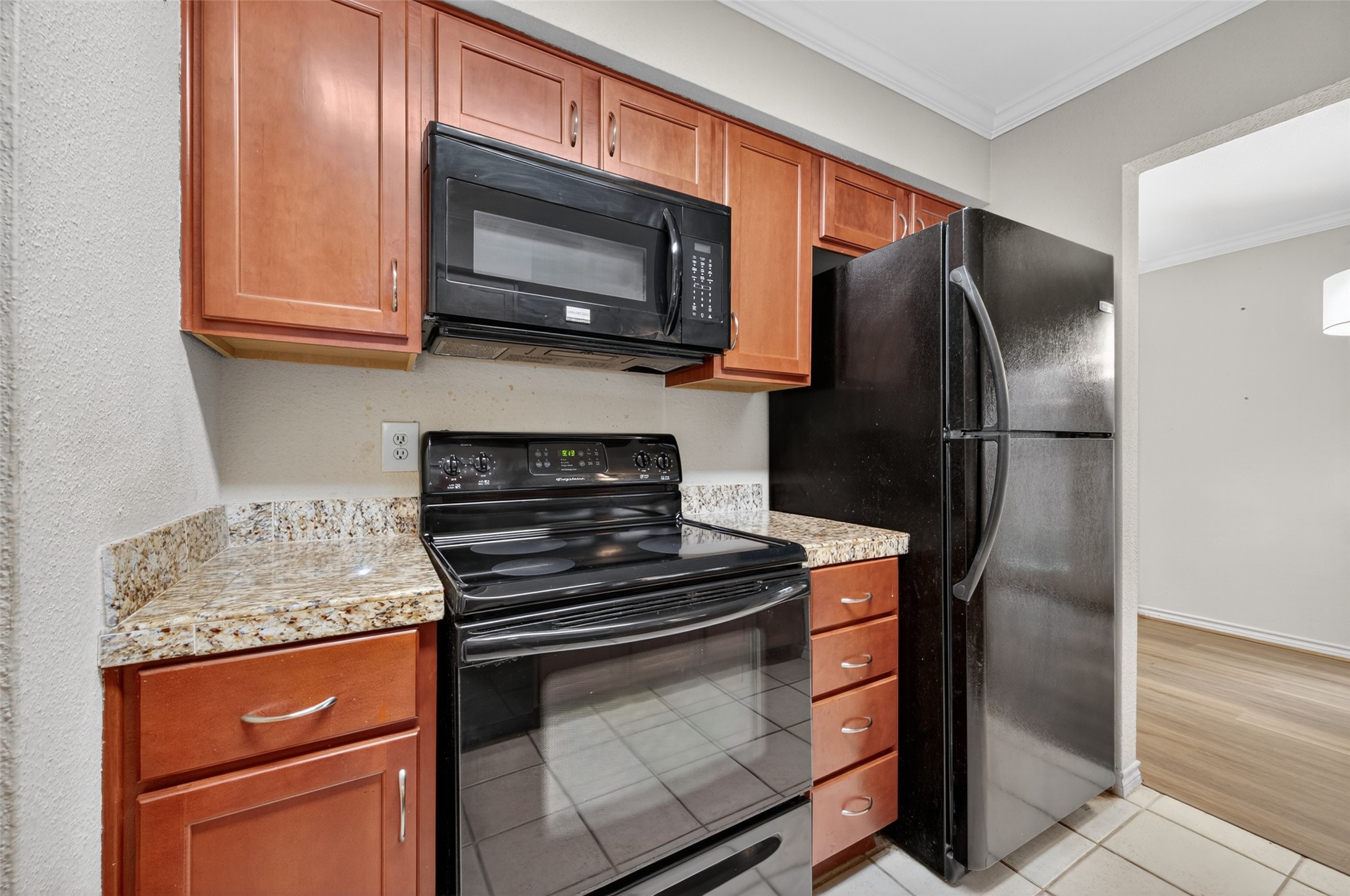2211 South Kirkwood Road, Unit 49 Houston, TX 77077 - Photo 19 of 34 a kitchen with stainless steel appliances granite countertop a stove microwave and refrigerator
