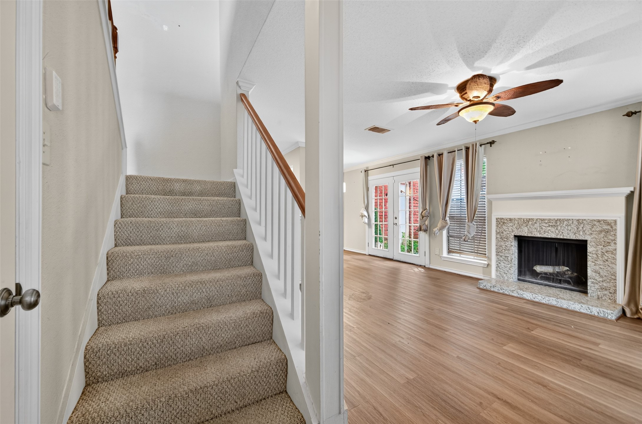 2211 South Kirkwood Road, Unit 49 Houston, TX 77077 - Photo 22 of 34 a view of a livingroom with wooden floor and a ceiling fan