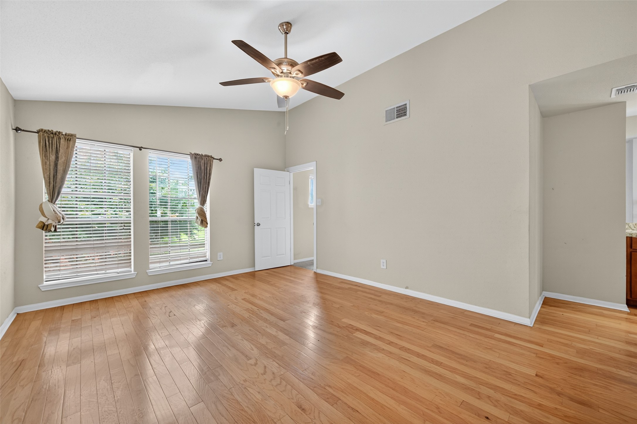 2211 South Kirkwood Road, Unit 49 Houston, TX 77077 - Photo 25 of 34 a view of an empty room with wooden floor and a window