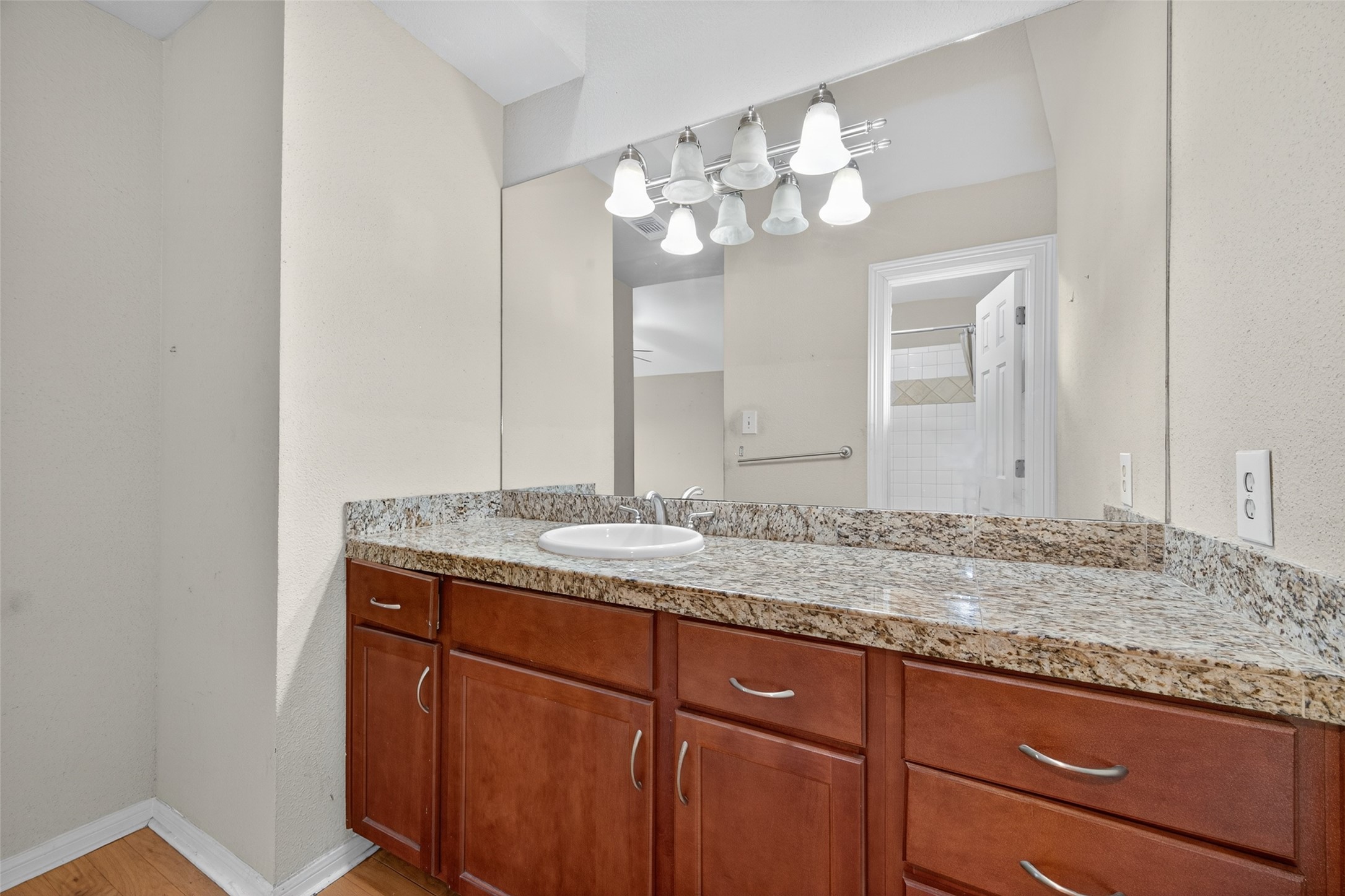 2211 South Kirkwood Road, Unit 49 Houston, TX 77077 - Photo 30 of 34 a bathroom with a granite countertop sink and a mirror