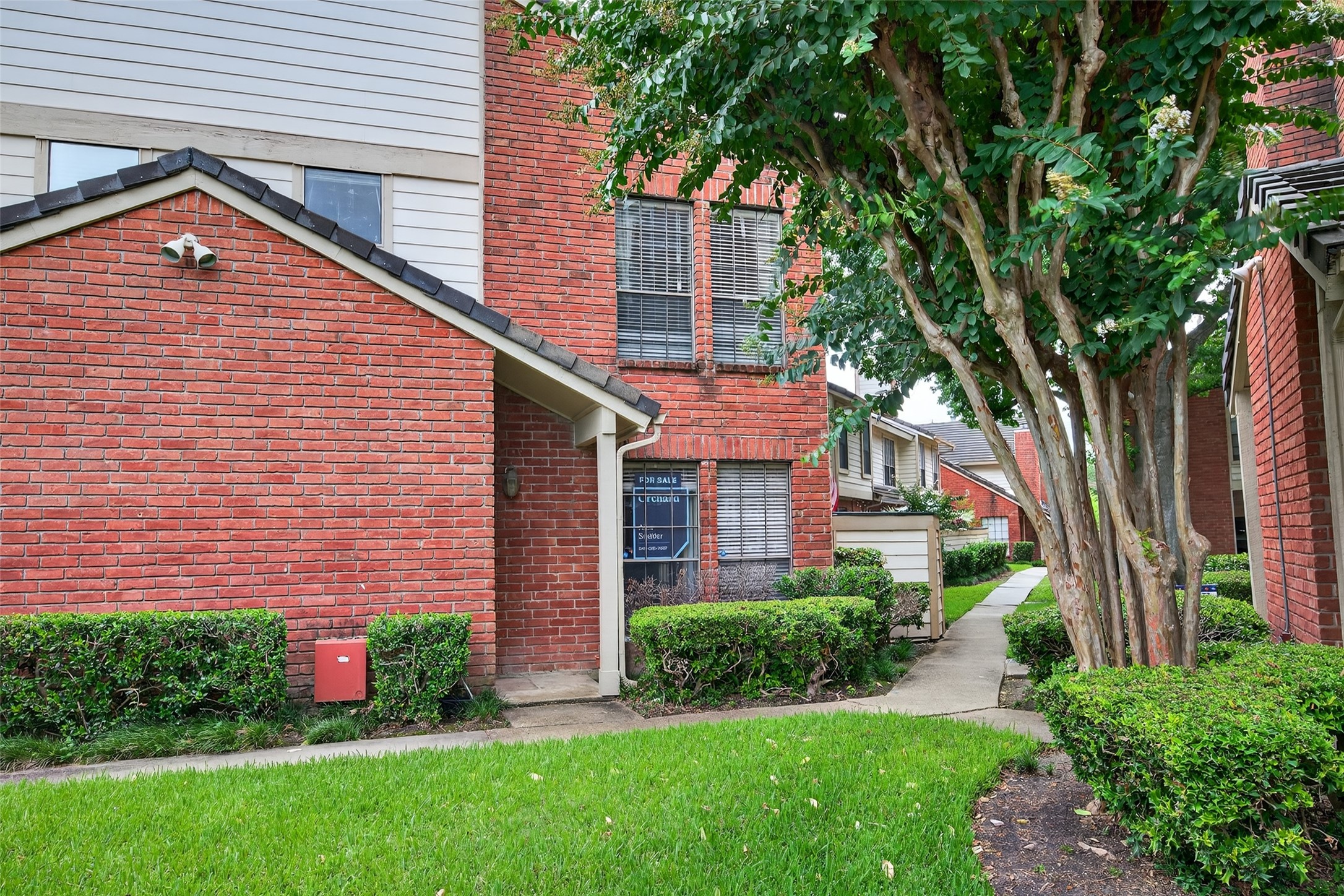 2211 South Kirkwood Road, Unit 49 Houston, TX 77077 - Photo 3 of 34 a front view of a house with a yard