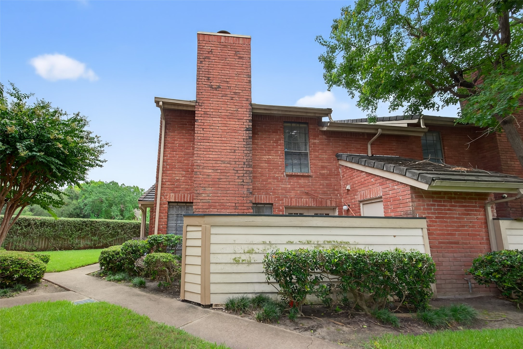 2211 South Kirkwood Road, Unit 49 Houston, TX 77077 - Photo 4 of 34 a front view of a house with a yard