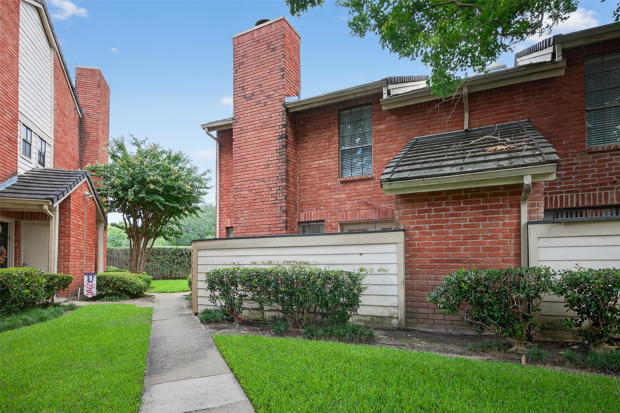 2211 South Kirkwood Road, Unit 49 Houston, TX 77077 - Photo 5 of 34 a front view of a house with a garden