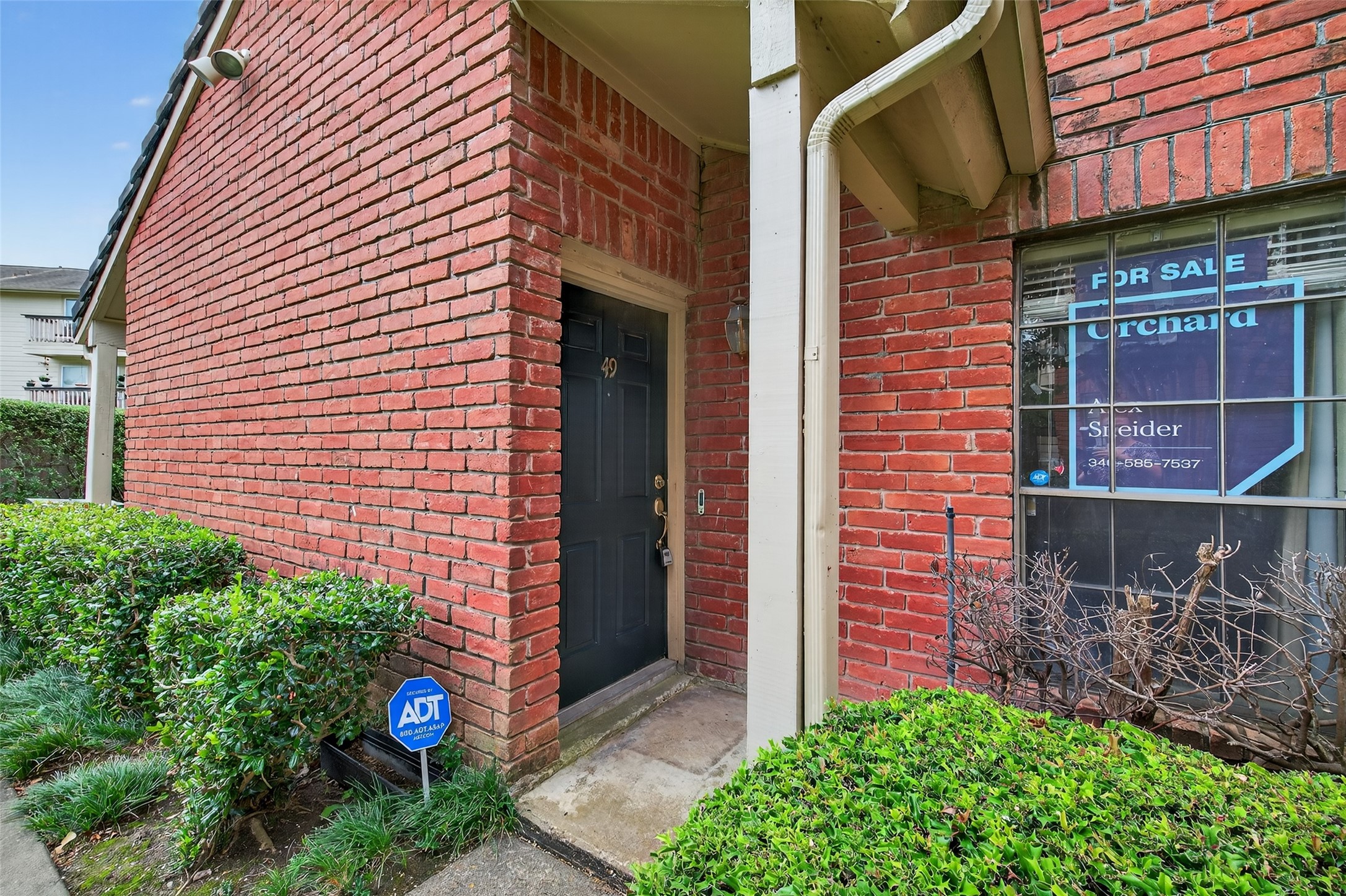 2211 South Kirkwood Road, Unit 49 Houston, TX 77077 - Photo 6 of 34 a view of a brick house with a potted plant and a potted plant