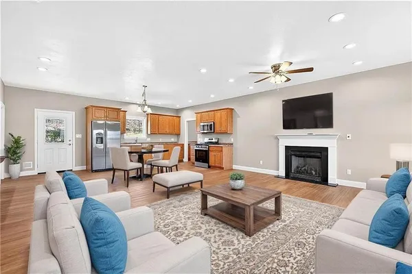 a living room with furniture a fireplace and a flat screen tv