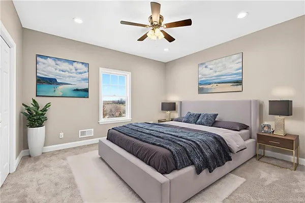 a bedroom with a large bed couch and a window