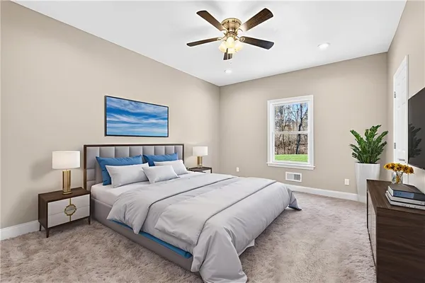 a bedroom with a large bed and a chandelier