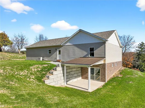 a living room with furniture and view of kitchen