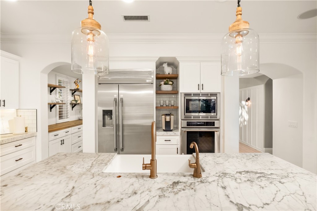 12 Ardennes Drive Ladera Ranch, CA 92694 - Photo 12 of 58 a kitchen with a refrigerator and a stove top oven