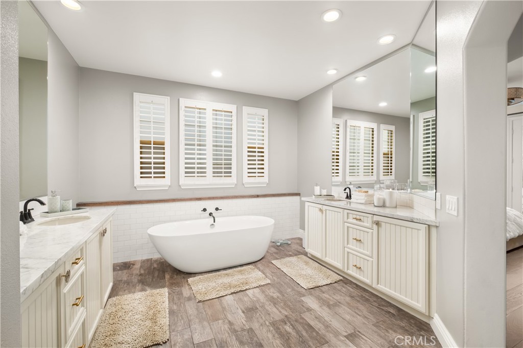 12 Ardennes Drive Ladera Ranch, CA 92694 - Photo 18 of 58 a spacious bathroom with a double vanity sink large mirror and a bathtub