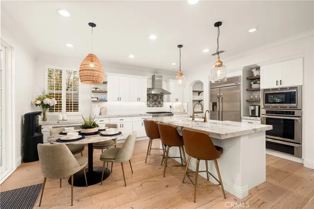 a kitchen with stainless steel appliances kitchen island granite countertop a sink and a stove