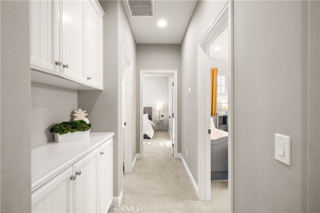 12 Ardennes Drive Ladera Ranch, CA 92694 - Photo 35 of 58 a view of a hallway with bathroom and wooden floor