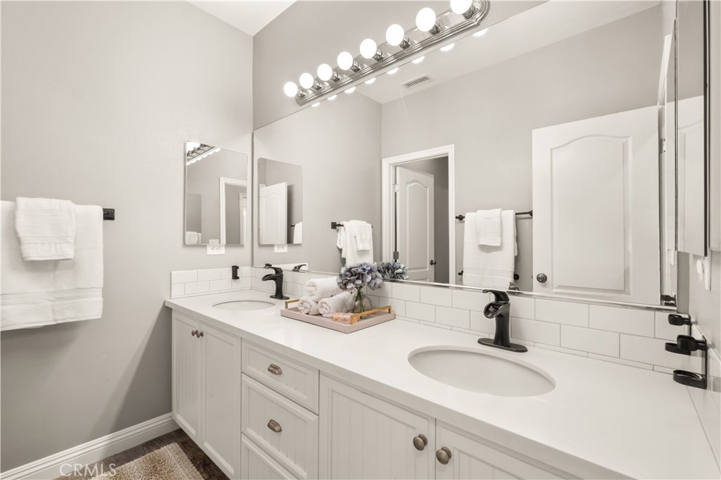 12 Ardennes Drive Ladera Ranch, CA 92694 - Photo 39 of 58 a bathroom with a double vanity sink and a mirror