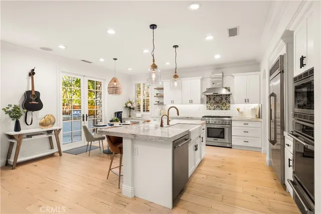 a kitchen with stainless steel appliances kitchen island granite countertop a sink and cabinets