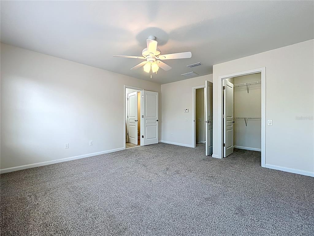 12930 Vennetta Way Windermere, FL 34786 - Photo 18 of 38 an empty room with closet and a ceiling fan