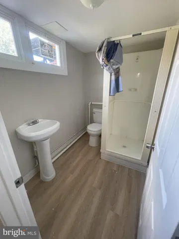 a bathroom with a sink a toilet and mirror