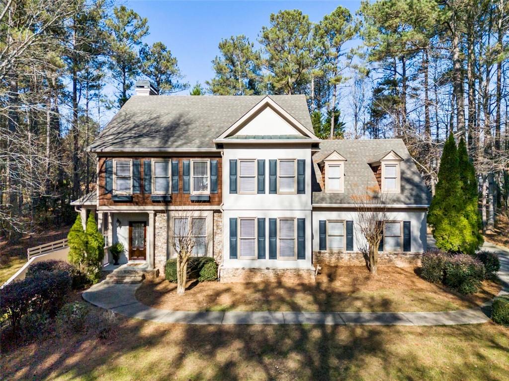 2120 Country Ridge Road Milton, GA 30004 - Photo 1 of 1 a front view of a house with a garden