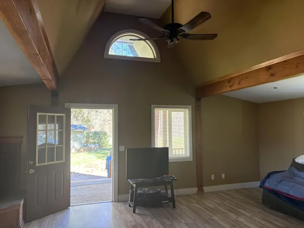 a living room with furniture and wooden floor