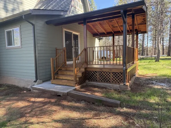 a view of a balcony with wooden floor and wooden fence