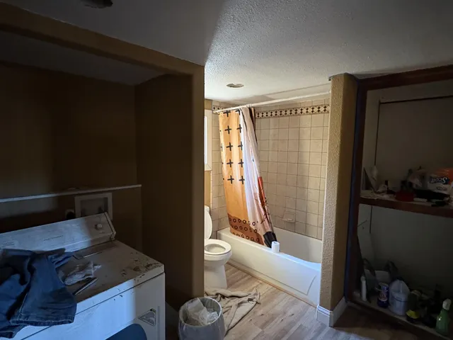 a bathroom with a tub toilet and sink