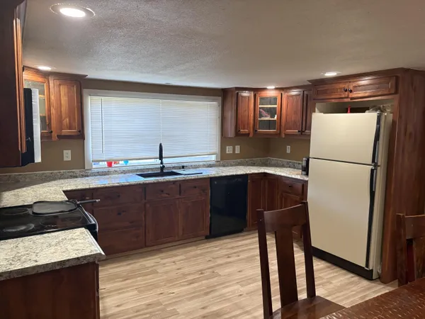 a kitchen with a refrigerator and a sink