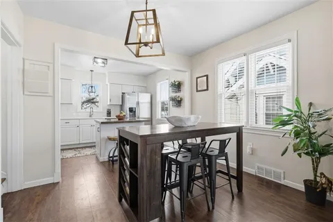 a kitchen with stainless steel appliances kitchen island granite countertop a refrigerator and a stove top oven