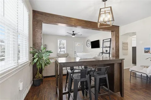 a kitchen with stainless steel appliances a sink a window and cabinets