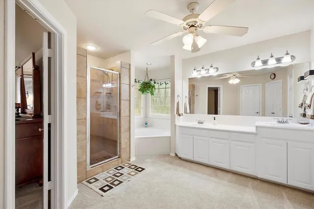 a spacious bathroom with a bathtub shower sink and mirror