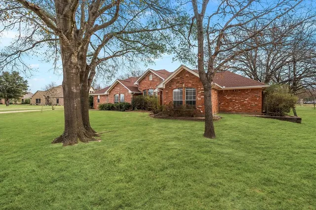a view of a house with a tree in a yard