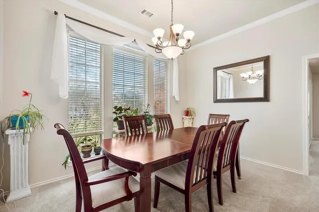 a view of a dining room with furniture and chandelier