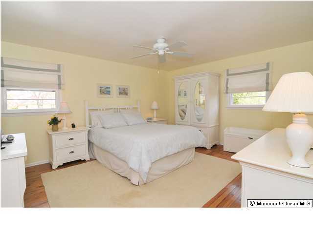 861 Colts Neck Road Freehold, NJ 07728 - Photo 14 of 25 a bedroom with a bed and wooden floor