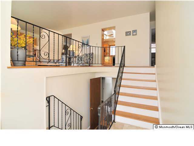 861 Colts Neck Road Freehold, NJ 07728 - Photo 21 of 25 a view of entryway and hall with wooden floor