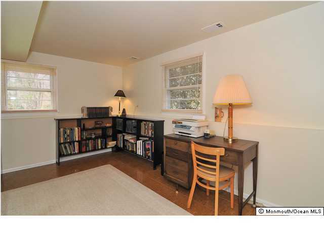 861 Colts Neck Road Freehold, NJ 07728 - Photo 23 of 25 a living room with furniture a lamp and a window