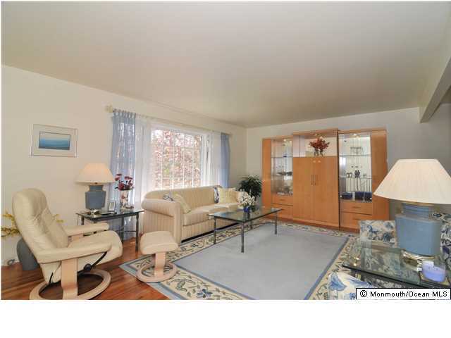861 Colts Neck Road Freehold, NJ 07728 - Photo 4 of 25 a living room with furniture a window and a table